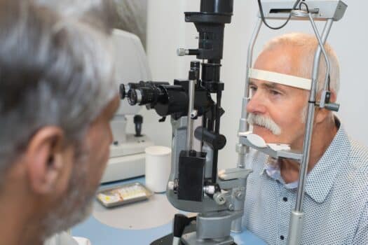 homme âgé en cours d'examen visuel pour illustrer la formation continue opticien ICO CMO en pathologies du malvoyant et leurs évolutions